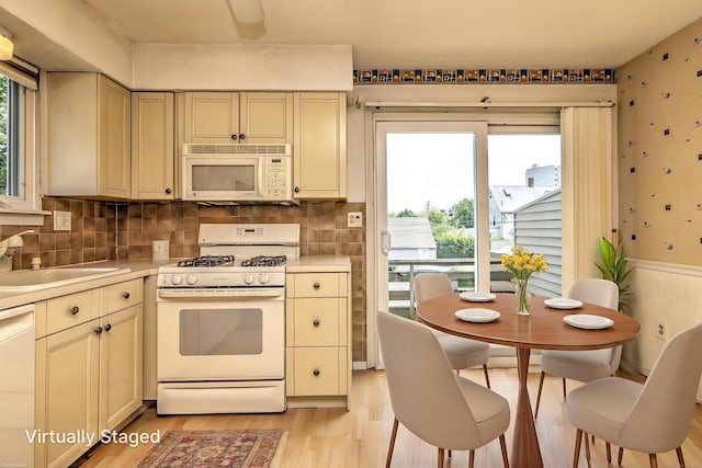 269 Captain Thomas Blvd Unit 12, West Haven, CT 06516 - kitchen featuring white appliances, a sink, cream cabinets, light wood-style floors, and light countertops