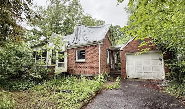 37 Thorpe Ave, Meriden, CT 06450 - view of front of home with driveway, an attached garage, and brick siding