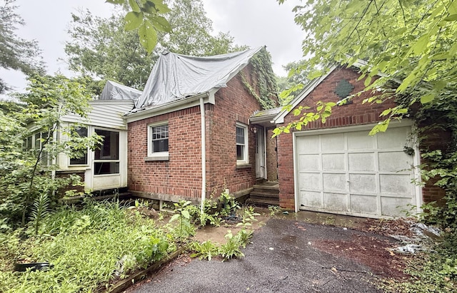 37 Thorpe Ave, Meriden, CT 06450 - view of property exterior featuring driveway, a garage, and brick siding