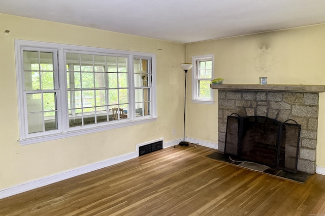 37 Thorpe Ave, Meriden, CT 06450 - unfurnished living room with hardwood / wood-style floors, baseboards, and a stone fireplace