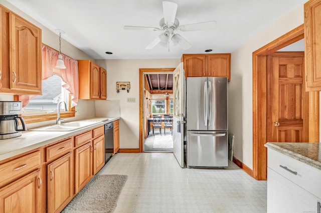 40 Cutspring Rd, Stratford, CT 06614 - kitchen with freestanding refrigerator, dishwashing machine, light countertops, a ceiling fan, and light flooring