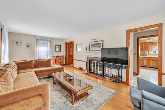 40 Cutspring Rd, Stratford, CT 06614 - living area featuring a brick fireplace, light wood-style floors, and ceiling fan