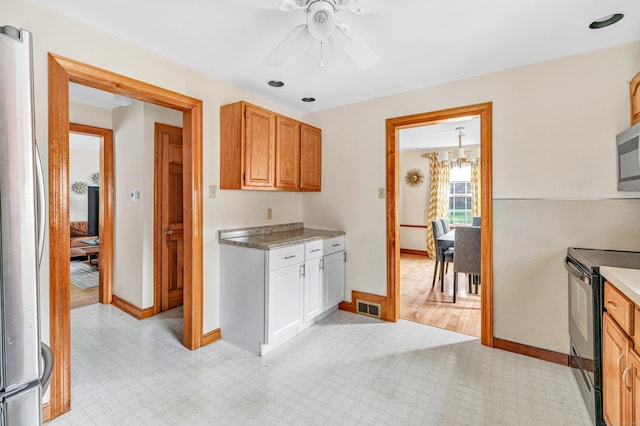 40 Cutspring Rd, Stratford, CT 06614 - kitchen featuring appliances with stainless steel finishes, light flooring, light countertops, a ceiling fan, and a chandelier