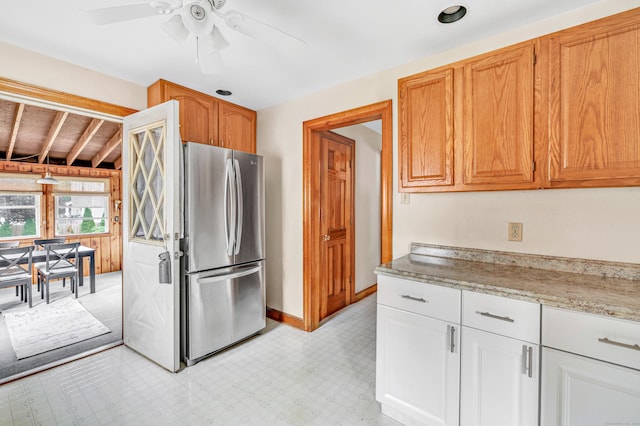 40 Cutspring Rd, Stratford, CT 06614 - kitchen featuring freestanding refrigerator, ceiling fan, and light stone countertops
