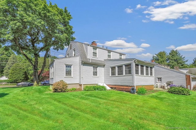 40 Cutspring Rd, Stratford, CT 06614 - back of property with a chimney and a lawn