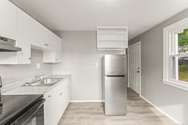 101 Cannon Rd, East Hartford, CT 06108 - kitchen featuring freestanding refrigerator, black electric range, extractor fan, a sink, and light wood finished floors