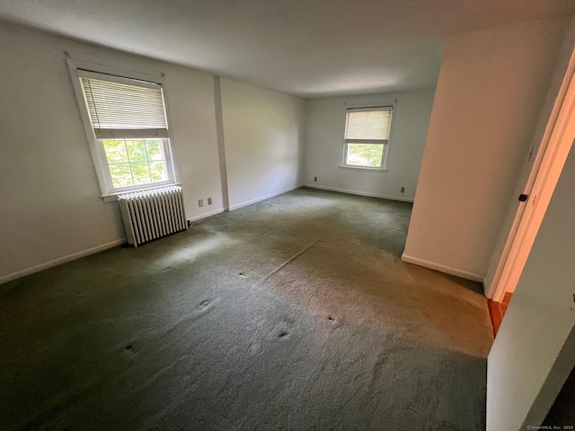 337 Charles St, Torrington, CT 06790 - empty room with radiator heating unit, baseboards, and carpet flooring
