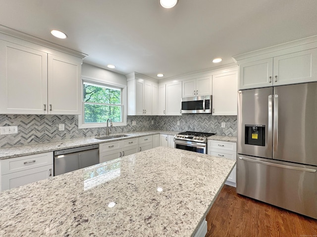 17 Currituck Rd, Newtown, CT 06470 - kitchen with stainless steel appliances, a sink, white cabinetry, dark wood-style floors, and light stone counters