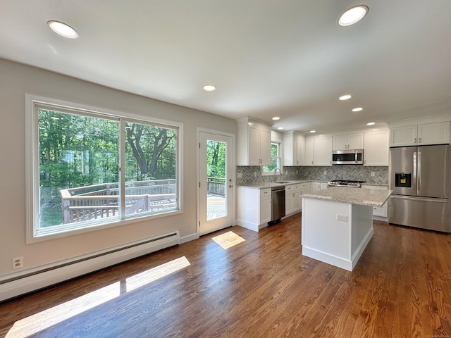 17 Currituck Rd, Newtown, CT 06470 - kitchen featuring stainless steel appliances, baseboard heating, a sink, backsplash, and white cabinetry