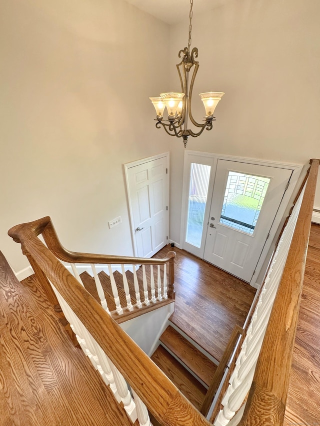 17 Currituck Rd, Newtown, CT 06470 - foyer featuring a chandelier, wood finished floors, stairs, a high ceiling, and baseboards