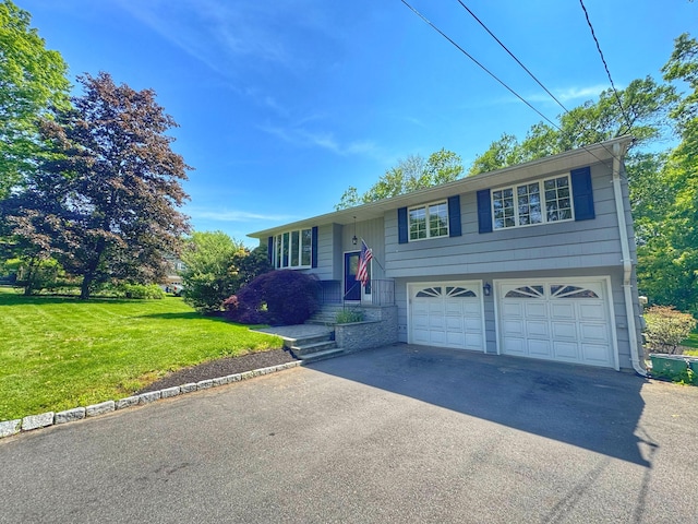 17 Currituck Rd, Newtown, CT 06470 - split foyer home featuring a garage, driveway, and a front yard
