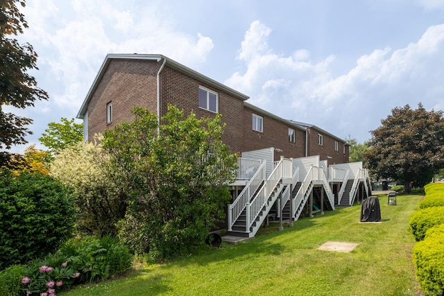 30 Sheila Ct Apt 31, Bristol, CT 06010 - rear view of house with stairs, brick siding, a deck, and a yard