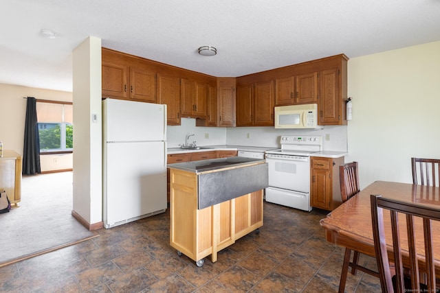 30 Sheila Ct Apt 31, Bristol, CT 06010 - kitchen with white appliances, a sink, a center island, brown cabinets, and stone finish floors