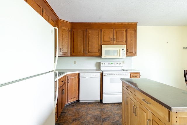 30 Sheila Ct Apt 31, Bristol, CT 06010 - kitchen with white appliances, dark stone finish floors, brown cabinets, and a textured ceiling