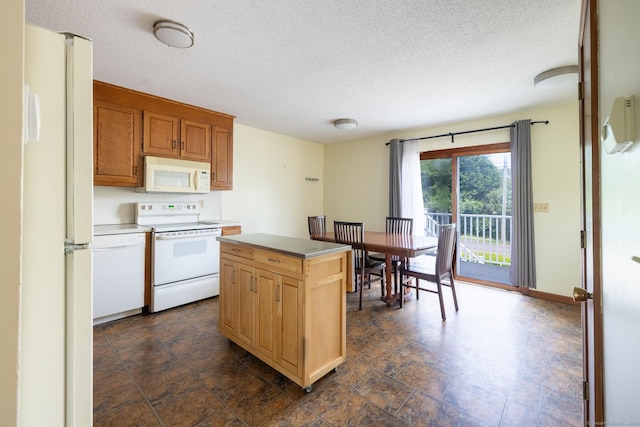30 Sheila Ct Apt 31, Bristol, CT 06010 - kitchen with white appliances, a textured ceiling, light countertops, and a center island