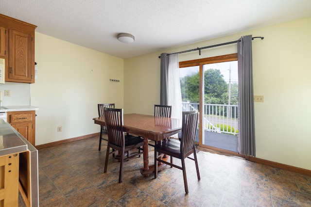 30 Sheila Ct Apt 31, Bristol, CT 06010 - dining area featuring baseboards, stone finish floors, and a textured ceiling