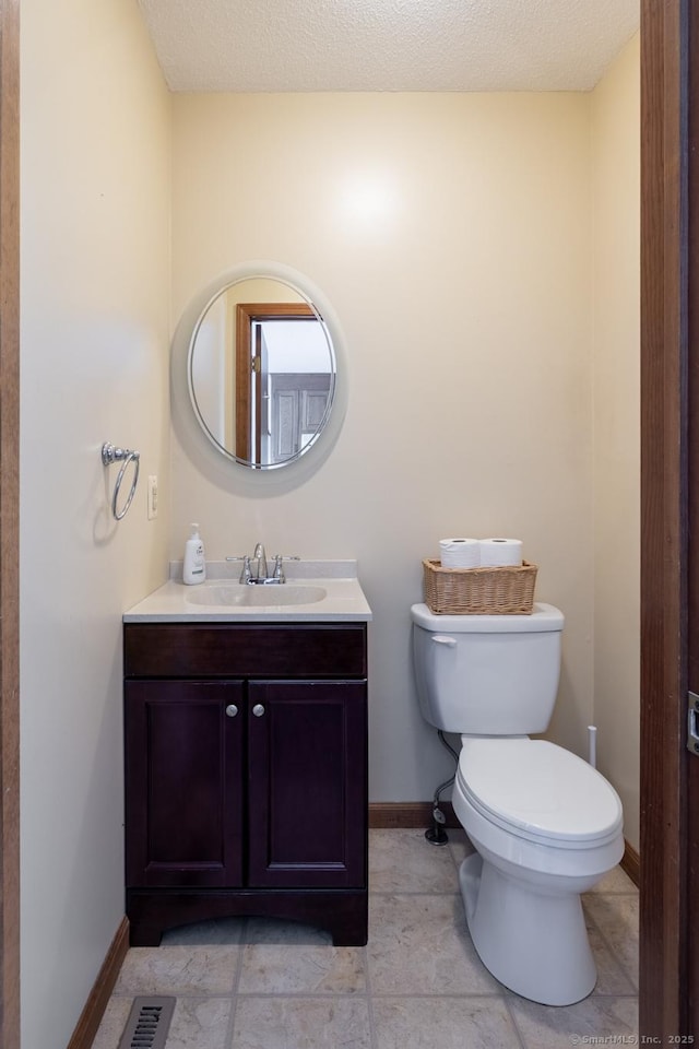 30 Sheila Ct Apt 31, Bristol, CT 06010 - half bath featuring vanity, toilet, baseboards, and a textured ceiling