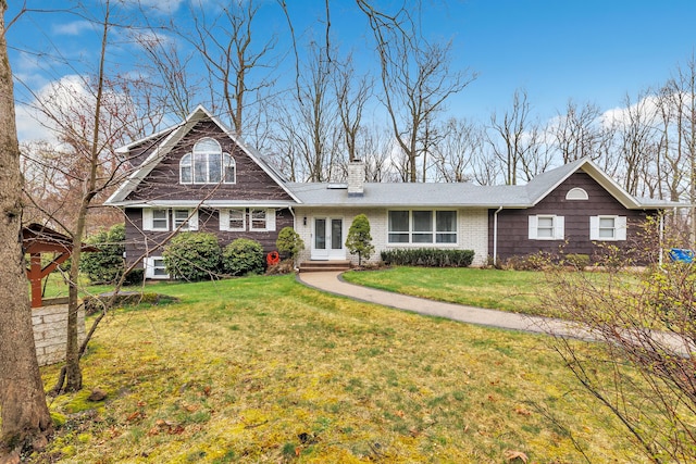 575 W Todd St, Hamden, CT 06518 - view of front of house featuring french doors, a chimney, a front yard, and brick siding