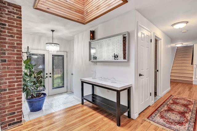 575 W Todd St, Hamden, CT 06518 - foyer entrance with stairs, a chandelier, light wood finished floors, and baseboards
