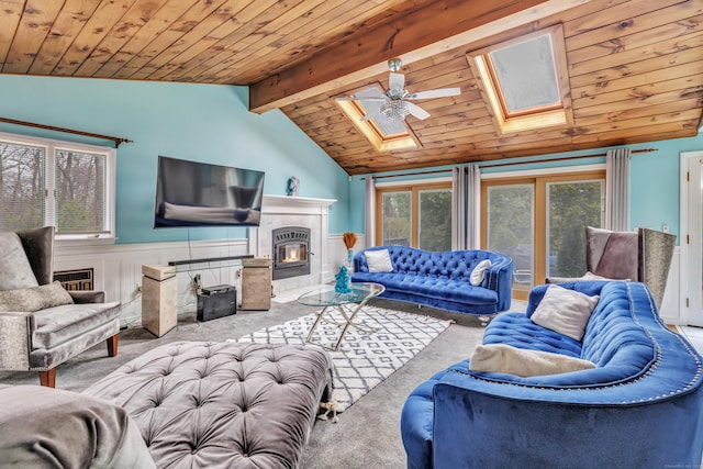 575 W Todd St, Hamden, CT 06518 - carpeted living room with a skylight, a wainscoted wall, wooden ceiling, a ceiling fan, and a tiled fireplace