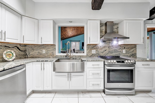 575 W Todd St, Hamden, CT 06518 - kitchen with wall chimney exhaust hood, stainless steel appliances, a sink, lofted ceiling, and white cabinets