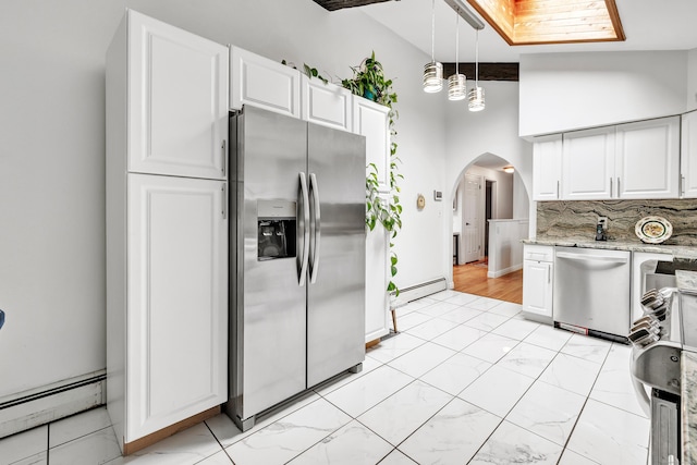575 W Todd St, Hamden, CT 06518 - kitchen with appliances with stainless steel finishes, baseboard heating, arched walkways, and white cabinets