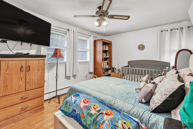 575 W Todd St, Hamden, CT 06518 - bedroom featuring a baseboard radiator, light wood-style floors, and a ceiling fan