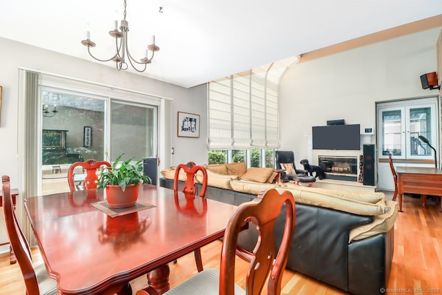 230 New Canaan Ave Apt 2, Norwalk, CT 06850 - dining room featuring light wood-type flooring, a chandelier, and a glass covered fireplace
