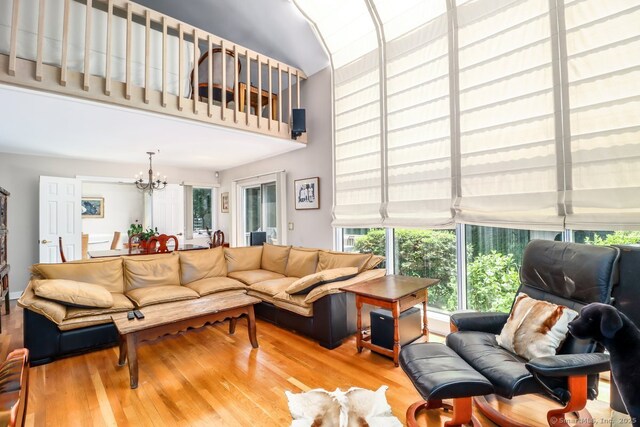 230 New Canaan Ave Apt 2, Norwalk, CT 06850 - living room featuring a chandelier, wood finished floors, and a high ceiling