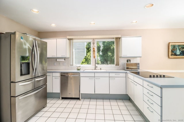 230 New Canaan Ave Apt 2, Norwalk, CT 06850 - kitchen featuring appliances with stainless steel finishes, a sink, a peninsula, light countertops, and tasteful backsplash