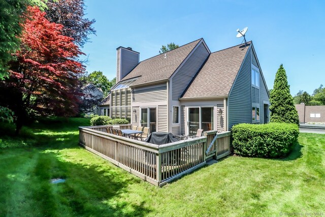 230 New Canaan Ave Apt 2, Norwalk, CT 06850 - back of house with a chimney, a lawn, and a shingled roof