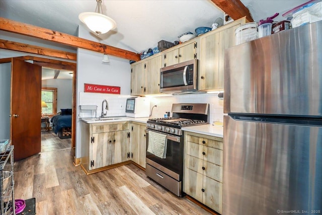 206 Litchfield Tpke, Washington, CT 06777 - kitchen featuring appliances with stainless steel finishes, light countertops, a sink, backsplash, and light wood finished floors