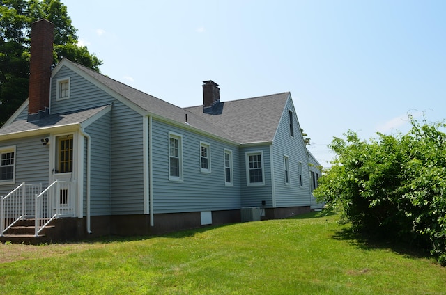 55 Cloudland Rd, North Haven, CT 06473 - rear view of property with a chimney, a yard, and roof with shingles
