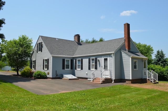 55 Cloudland Rd, North Haven, CT 06473 - back of house with a chimney, a lawn, and a shingled roof