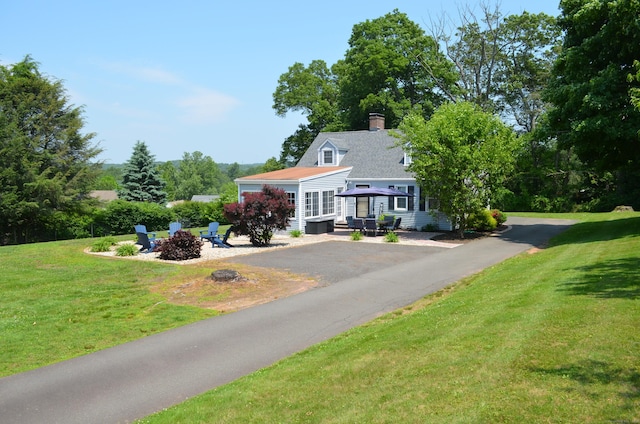 55 Cloudland Rd, North Haven, CT 06473 - view of front of house featuring a fire pit, a front lawn, and a chimney