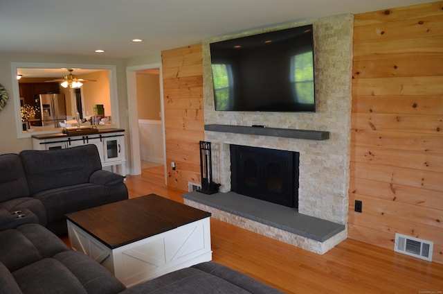 55 Cloudland Rd, North Haven, CT 06473 - living room with wood finished floors, a ceiling fan, a stone fireplace, and recessed lighting