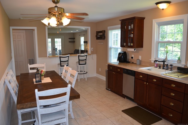 55 Cloudland Rd, North Haven, CT 06473 - kitchen with stainless steel dishwasher, a ceiling fan, glass insert cabinets, light countertops, and light tile patterned floors