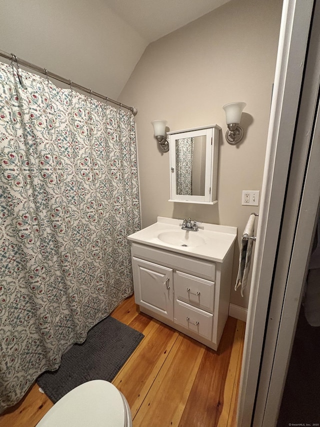 55 Cloudland Rd, North Haven, CT 06473 - bathroom with wood finished floors, vanity, lofted ceiling, and a shower with shower curtain