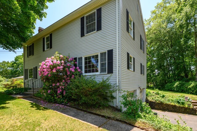 791 Ives Row, Cheshire, CT 06410 - view of side of property with a chimney, an attached garage, and a yard
