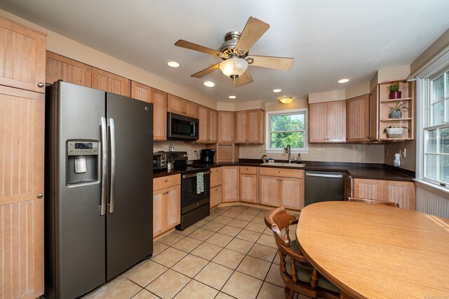 791 Ives Row, Cheshire, CT 06410 - kitchen featuring stainless steel appliances, light brown cabinets, dark countertops, light tile patterned floors, and a sink