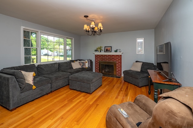 791 Ives Row, Cheshire, CT 06410 - living room featuring light wood-style floors, a chandelier, and a brick fireplace