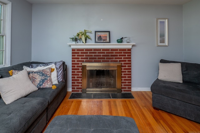 791 Ives Row, Cheshire, CT 06410 - living room with a brick fireplace, wood finished floors, and baseboards