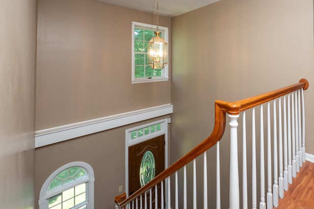 791 Ives Row, Cheshire, CT 06410 - stairway featuring wood finished floors, healthy amount of natural light, a chandelier, and baseboards