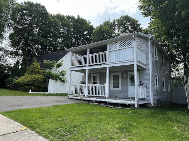 72 Beech St, Bristol, CT 06010 - townhome / multi-family property with a balcony, covered porch, and a front yard