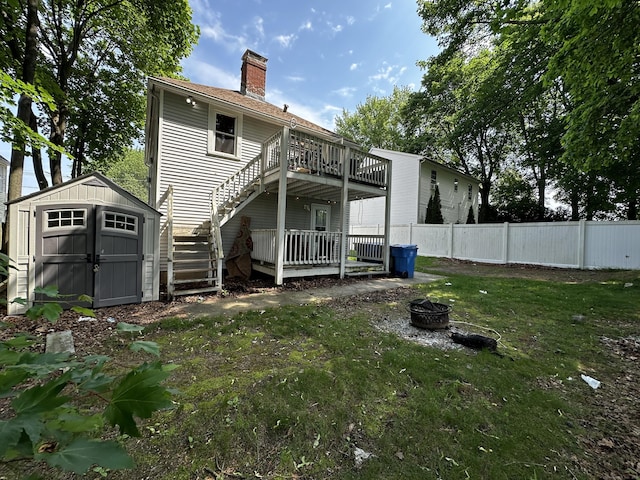 72 Beech St, Bristol, CT 06010 - rear view of house with a fire pit, a storage unit, stairway, a wooden deck, and a chimney