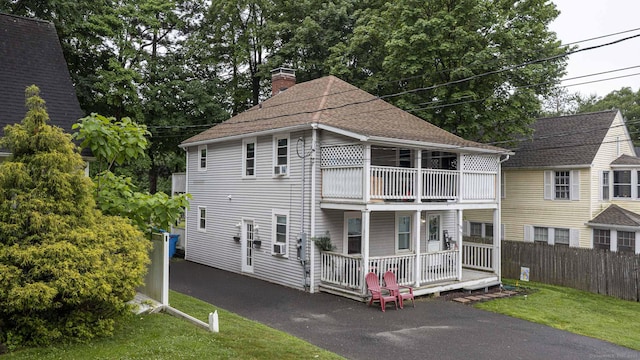 72 Beech St, Bristol, CT 06010 - view of front of property with a chimney, a balcony, covered porch, and a shingled roof