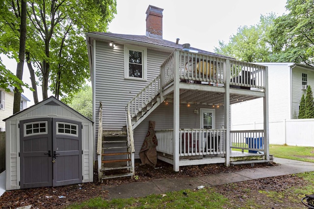 72 Beech St, Bristol, CT 06010 - rear view of property featuring stairs, a storage unit, a chimney, and a deck