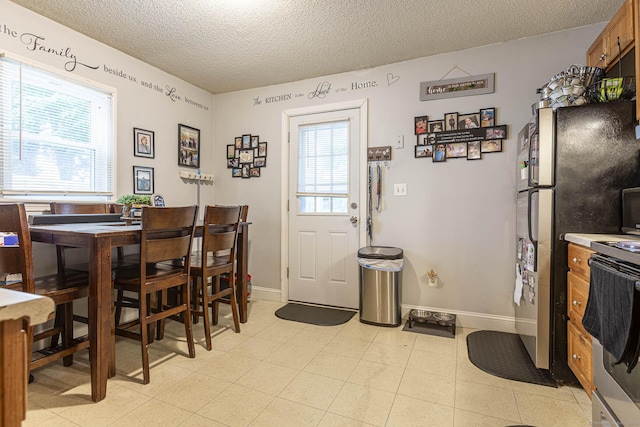 72 Beech St, Bristol, CT 06010 - dining room with a textured ceiling and baseboards