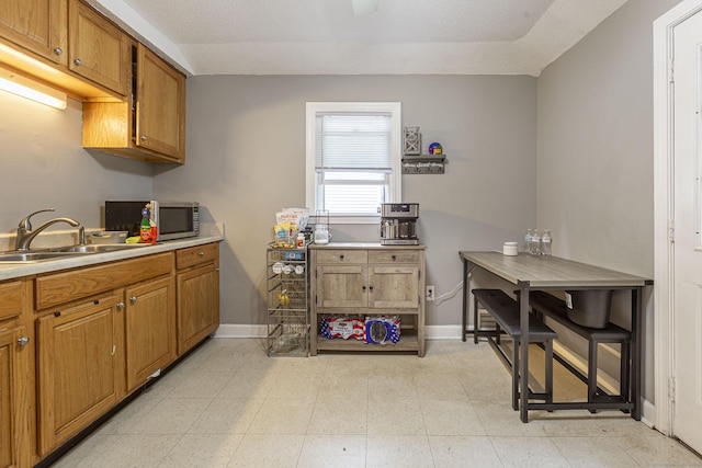 72 Beech St, Bristol, CT 06010 - kitchen with stainless steel microwave, brown cabinets, and light countertops