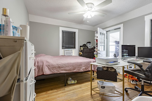 72 Beech St, Bristol, CT 06010 - bedroom featuring hardwood / wood-style flooring, a textured ceiling, cooling unit, an office area, and a ceiling fan